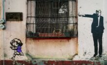 black metal window grill on white concrete wall